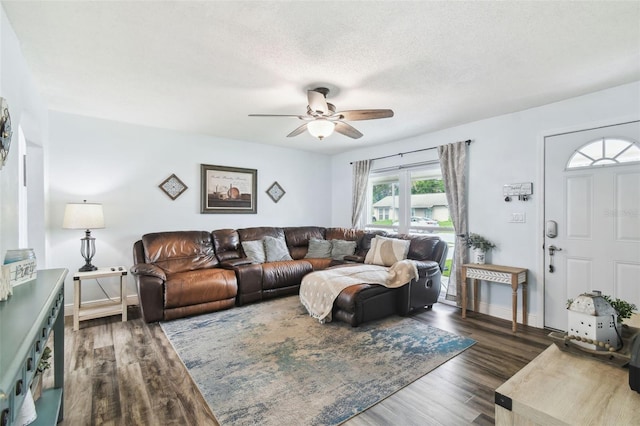 3628 Dellefield St, New Port Richey, FL 34655 - living area featuring ceiling fan, wood finished floors, baseboards, and a textured ceiling