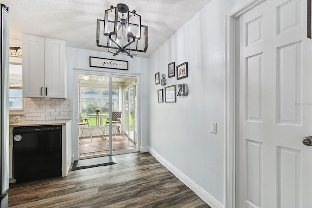 3628 Dellefield St, New Port Richey, FL 34655 - dining area with baseboards, a chandelier, dark wood-style floors, and a textured ceiling