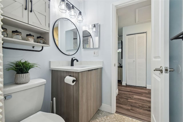 3628 Dellefield St, New Port Richey, FL 34655 - bathroom featuring a closet, vanity, toilet, and wood finished floors