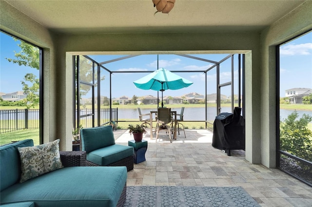 7116 Estero Ct, Apollo Beach, FL 33572 - sunroom featuring a water view, a residential view, outdoor dining space, and a ceiling fan