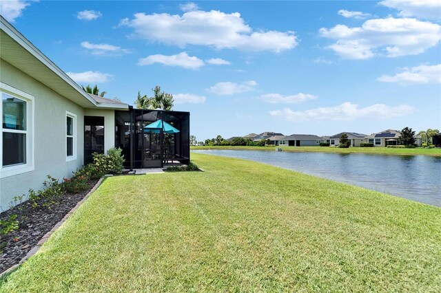 7116 Estero Ct, Apollo Beach, FL 33572 - view of grassy yard with a water view, glass enclosure, and a residential view