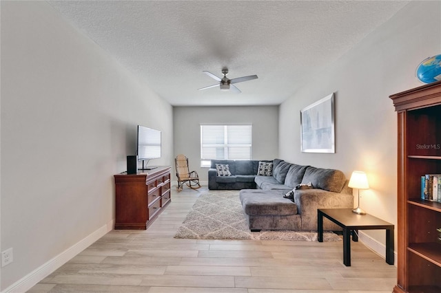 7116 Estero Ct, Apollo Beach, FL 33572 - living area featuring light wood finished floors, a ceiling fan, and a textured ceiling