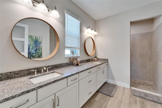 7116 Estero Ct, Apollo Beach, FL 33572 - full bathroom with double vanity, wood finished floors, plenty of natural light, and a walk in shower