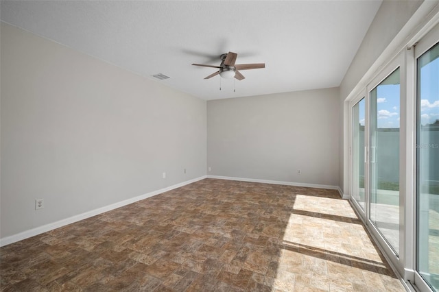 6841 Mitchell Cir, Tampa, FL 33634 - spare room with ceiling fan and stone finish floors