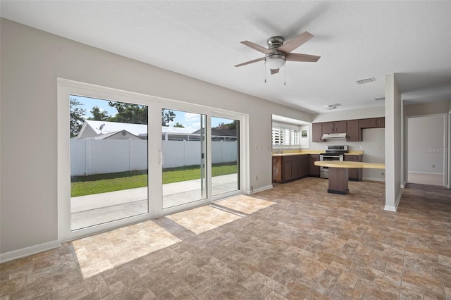 6841 Mitchell Cir, Tampa, FL 33634 - kitchen featuring electric range, under cabinet range hood, light countertops, dark brown cabinetry, and a ceiling fan