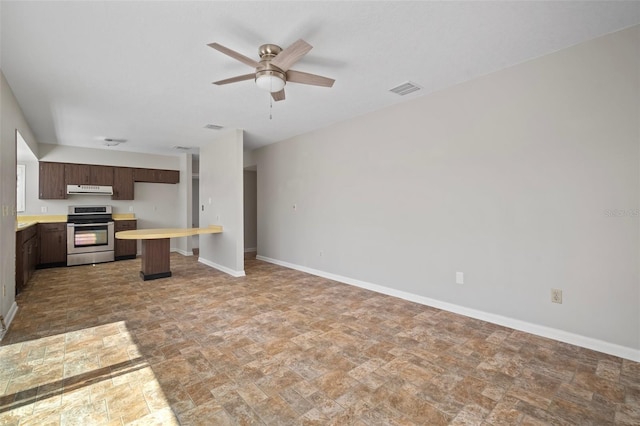 6841 Mitchell Cir, Tampa, FL 33634 - kitchen with stainless steel range with electric cooktop, stone finish floors, ventilation hood, and a ceiling fan
