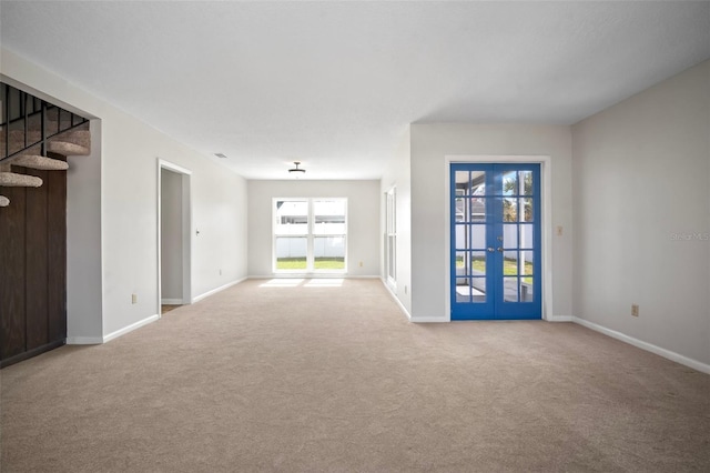6841 Mitchell Cir, Tampa, FL 33634 - spare room featuring carpet, french doors, and stairs