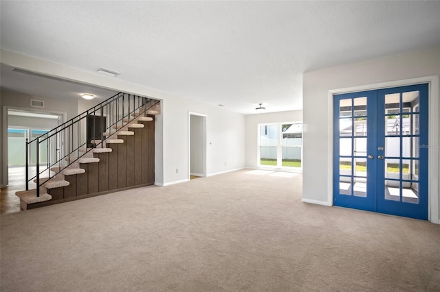 6841 Mitchell Cir, Tampa, FL 33634 - unfurnished living room featuring stairs, french doors, and carpet