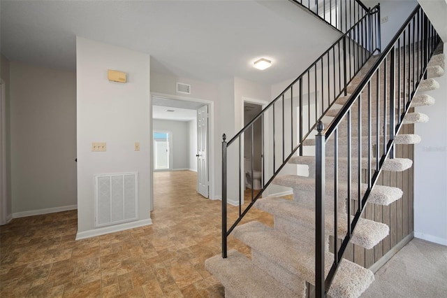 6841 Mitchell Cir, Tampa, FL 33634 - stairway with baseboards and stone finish floors