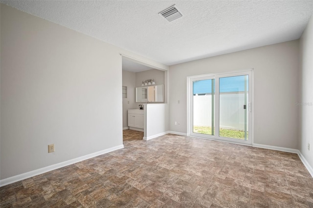 6841 Mitchell Cir, Tampa, FL 33634 - unfurnished living room with stone finish floors and a textured ceiling