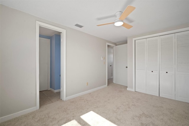 6841 Mitchell Cir, Tampa, FL 33634 - unfurnished bedroom with carpet, a closet, and a ceiling fan