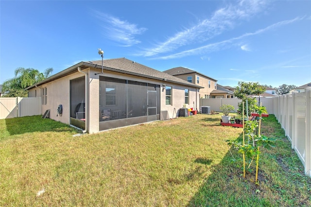 25200 Lambrusco Loop, Lutz, FL 33559 - rear view of house featuring a fenced backyard, a sunroom, stucco siding, and a vegetable garden