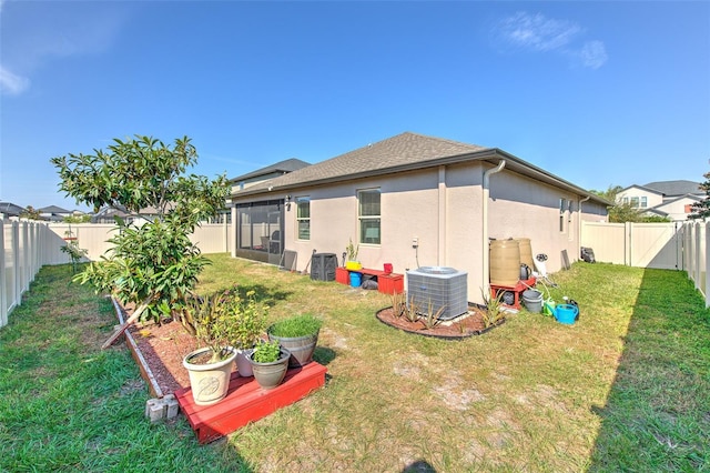 25200 Lambrusco Loop, Lutz, FL 33559 - back of house with stucco siding, a fenced backyard, roof with shingles, and a sunroom
