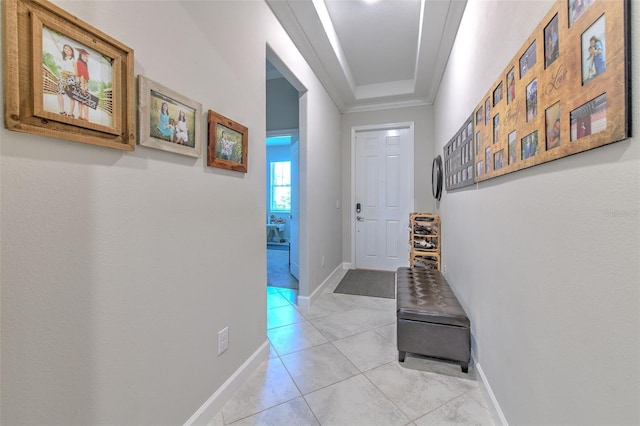 25200 Lambrusco Loop, Lutz, FL 33559 - hallway with light tile patterned floors, ornamental molding, and a tray ceiling