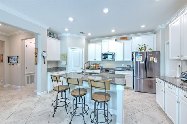 25200 Lambrusco Loop, Lutz, FL 33559 - kitchen with stainless steel appliances, recessed lighting, dark stone countertops, a breakfast bar area, and light tile patterned floors