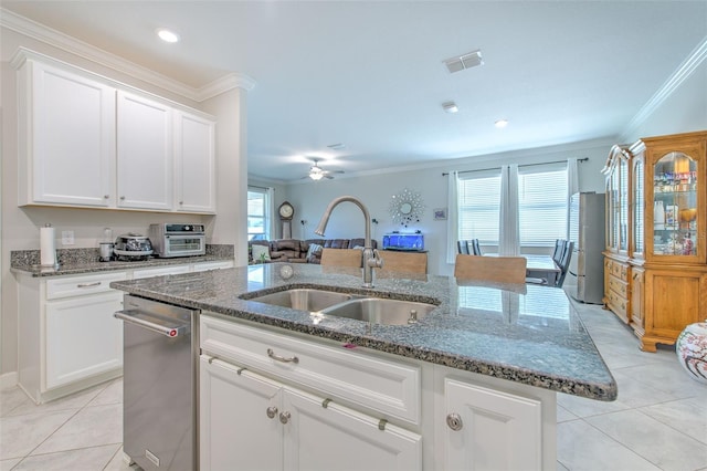 25200 Lambrusco Loop, Lutz, FL 33559 - kitchen with light tile patterned floors, an island with sink, ceiling fan, crown molding, and dark stone countertops