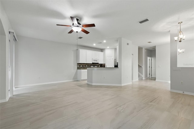 27563 Pleasure Ride Loop, Wesley Chapel, FL 33544 - unfurnished living room featuring a ceiling fan, recessed lighting, stairway, and a chandelier