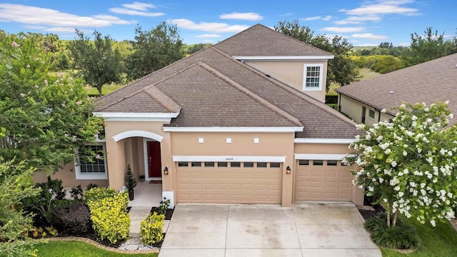 32624 Summerglade Dr, Wesley Chapel, FL 33545 - traditional-style house featuring stucco siding, a garage, concrete driveway, and a shingled roof