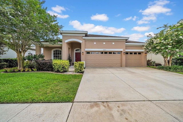 32624 Summerglade Dr, Wesley Chapel, FL 33545 - mediterranean / spanish-style home featuring stucco siding, an attached garage, a front yard, and driveway