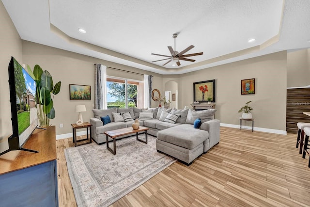 32624 Summerglade Dr, Wesley Chapel, FL 33545 - living area with a tray ceiling, light wood finished floors, ceiling fan, and recessed lighting