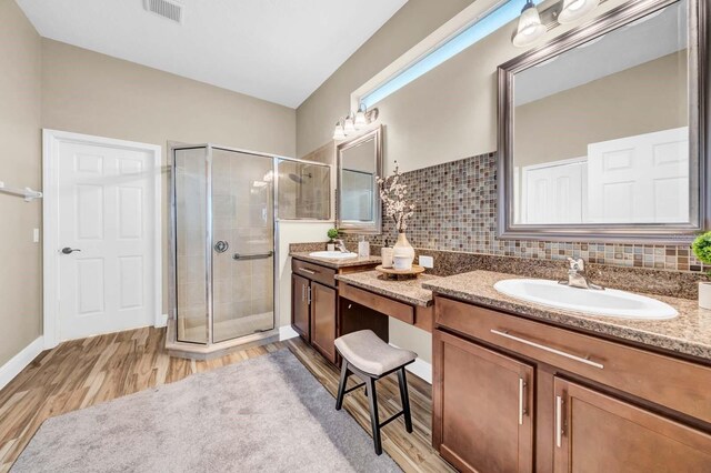 32624 Summerglade Dr, Wesley Chapel, FL 33545 - full bathroom featuring wood finished floors, vanity, and a shower stall