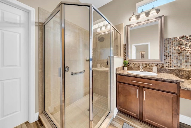 32624 Summerglade Dr, Wesley Chapel, FL 33545 - bathroom with vanity, a shower stall, decorative backsplash, and wood finished floors
