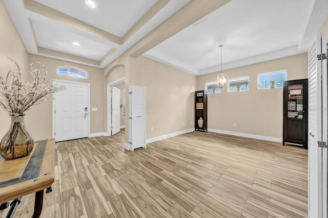 32624 Summerglade Dr, Wesley Chapel, FL 33545 - foyer entrance with a tray ceiling, a chandelier, light wood-style flooring, and recessed lighting