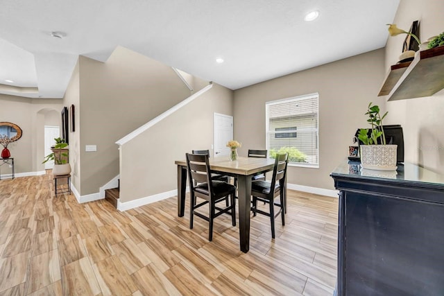 32624 Summerglade Dr, Wesley Chapel, FL 33545 - dining space with stairs, arched walkways, recessed lighting, and light wood finished floors