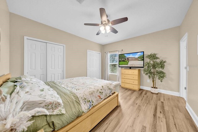 32624 Summerglade Dr, Wesley Chapel, FL 33545 - bedroom featuring two closets, light wood-type flooring, ceiling fan, and lofted ceiling