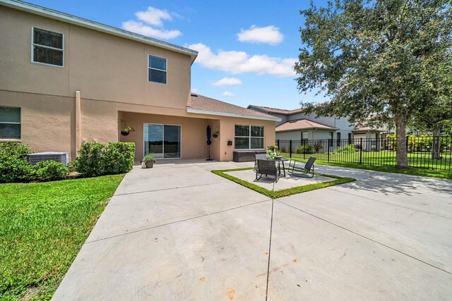 32624 Summerglade Dr, Wesley Chapel, FL 33545 - rear view of property with stucco siding and a patio