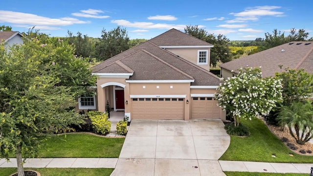 32624 Summerglade Dr, Wesley Chapel, FL 33545 - view of front facade featuring stucco siding, an attached garage, concrete driveway, roof with shingles, and a front lawn