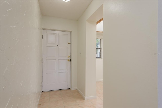 2650 Countryside Blvd Unit C204, Clearwater, FL 33761 - hall with light tile patterned flooring and a textured wall