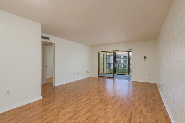 2650 Countryside Blvd Unit C204, Clearwater, FL 33761 - unfurnished room with light wood-style floors and a textured ceiling