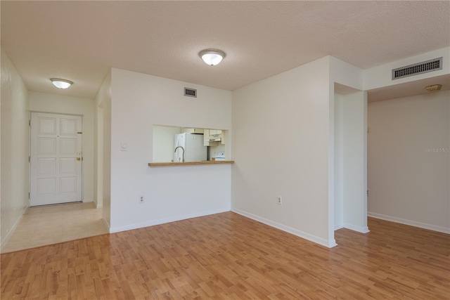 2650 Countryside Blvd Unit C204, Clearwater, FL 33761 - unfurnished room with wood finished floors, a smoke detector, and a textured ceiling