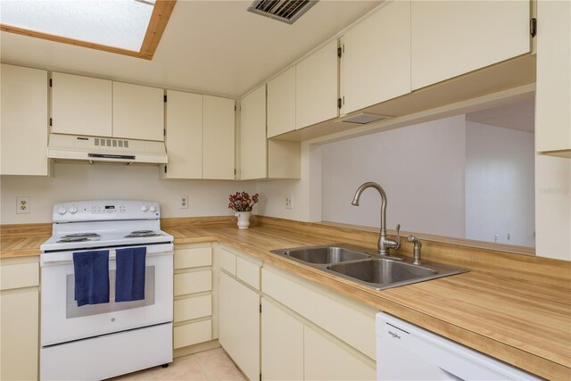 2650 Countryside Blvd Unit C204, Clearwater, FL 33761 - kitchen with white appliances, under cabinet range hood, and light countertops