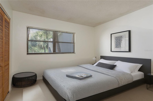 2650 Countryside Blvd Unit C204, Clearwater, FL 33761 - carpeted bedroom with a closet and a textured ceiling