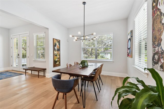 238 7th Ave S, Safety Harbor, FL 34695 - dining room with light wood-style floors, a chandelier, and french doors