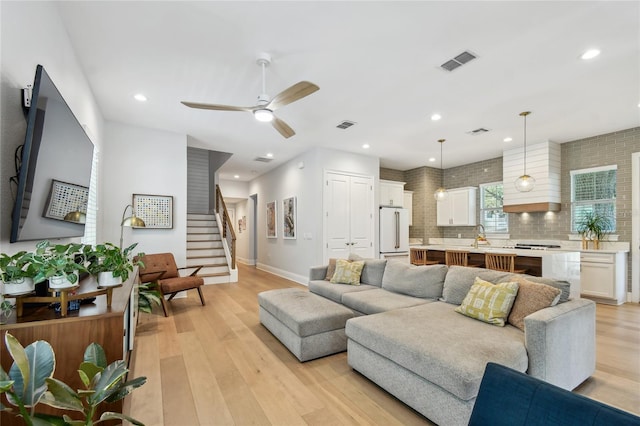 238 7th Ave S, Safety Harbor, FL 34695 - living room with light wood-style flooring, stairs, ceiling fan, and recessed lighting