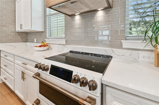 238 7th Ave S, Safety Harbor, FL 34695 - kitchen featuring white electric range oven, custom range hood, backsplash, white cabinetry, and light stone counters