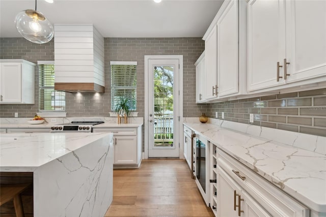 238 7th Ave S, Safety Harbor, FL 34695 - kitchen with decorative backsplash, white cabinetry, light wood-style floors, and wine cooler