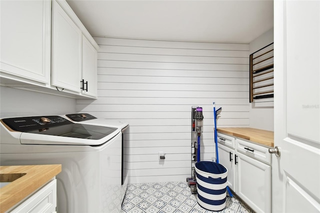 238 7th Ave S, Safety Harbor, FL 34695 - laundry area with washer and dryer, cabinet space, and wood walls