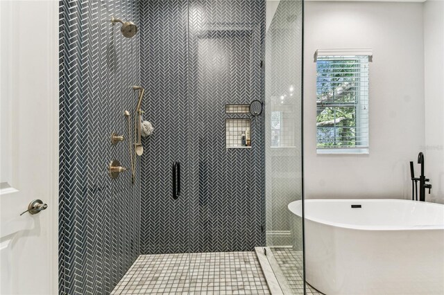 238 7th Ave S, Safety Harbor, FL 34695 - bathroom featuring a freestanding tub and tiled shower
