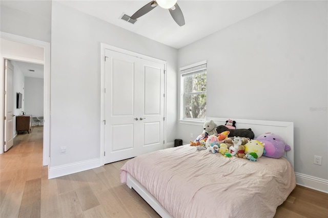 238 7th Ave S, Safety Harbor, FL 34695 - bedroom with light wood-style flooring, a closet, and a ceiling fan