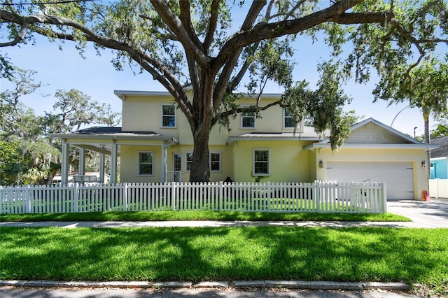 238 7th Ave S, Safety Harbor, FL 34695 - view of front of house featuring stucco siding, a garage, concrete driveway, and a fenced front yard