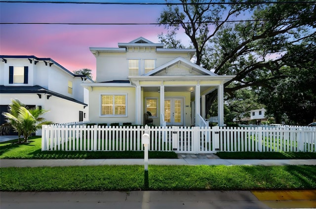 238 7th Ave S, Safety Harbor, FL 34695 - view of front of home with covered porch, french doors, and a fenced front yard