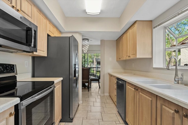 4777 Duhme Rd Unit 1D, Saint Petersburg, FL 33708 - kitchen with stainless steel appliances, light brown cabinetry, and light countertops
