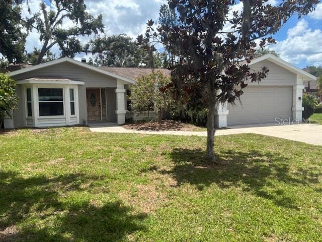 8033 55th St E, Palmetto, FL 34221 - view of front of house with a front yard, driveway, and an attached garage