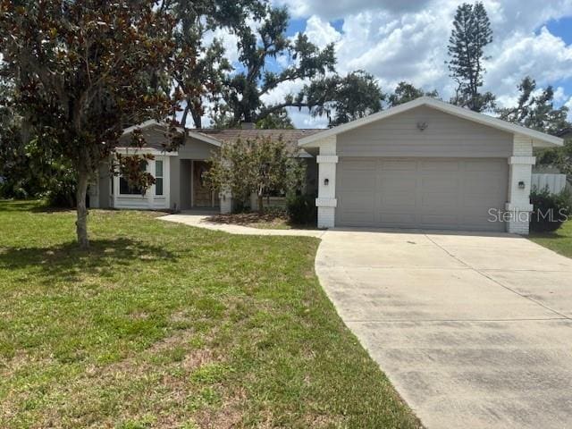 8033 55th St E, Palmetto, FL 34221 - ranch-style home with concrete driveway, a front lawn, and a garage