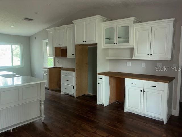 8033 55th St E, Palmetto, FL 34221 - kitchen featuring vaulted ceiling, dark wood-style flooring, white cabinets, and glass insert cabinets