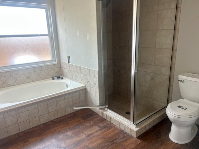 8033 55th St E, Palmetto, FL 34221 - full bath featuring wood finished floors, a bath, and a stall shower